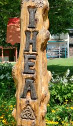 IHEA carved into the totem with a triquetra underneath